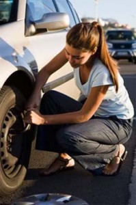 girl changing tire