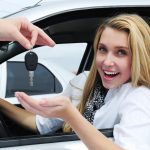 happy woman receiving car key