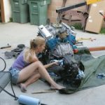 girl-working-on-engine-pic-300×225